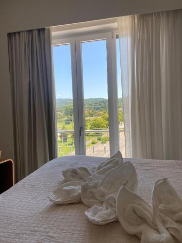 a bedroom with a bed with a large window at Home & B in Arezzo