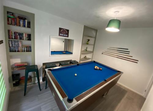 a living room with a pool table in it at Lime Cottage in Mountain Ash