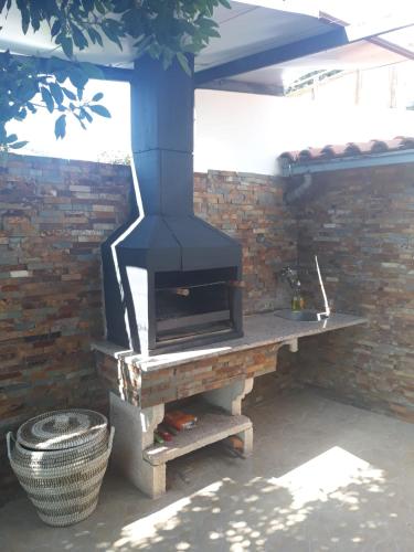 a brick wall with a stove in a patio at Casa das Laranjeiras in Pinhão