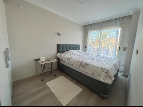 a small bedroom with a bed and a window at Villa Panorama in Cesme