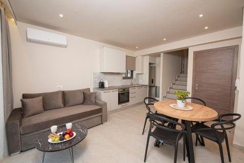 a living room with a couch and a table at Avali Deluxe Apartments in Lygia