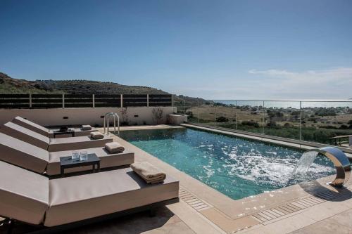 a swimming pool with a view of a mountain at Villas Paradise in Kalamaki by South Cretan Villas in Kalamaki