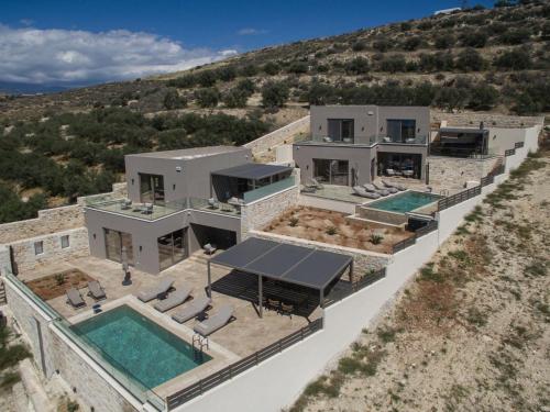 an aerial view of a house with two swimming pools at Villas Paradise in Kalamaki by South Cretan Villas in Kalamaki
