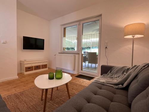 a living room with a couch and a table at Ferienhaus Naturtraum Eifel in Gerolstein