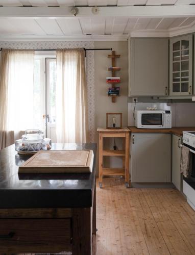 a kitchen with a table and a counter top at Lovely cabin with a beautiful view over Byske river in Byske