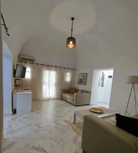 a large living room with a couch and a table at Walid cozy in Draria