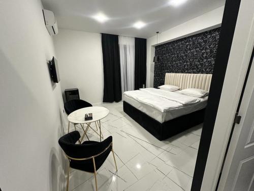 a bedroom with a bed and a table and chairs at Lux Plaza in Pʼarakʼar