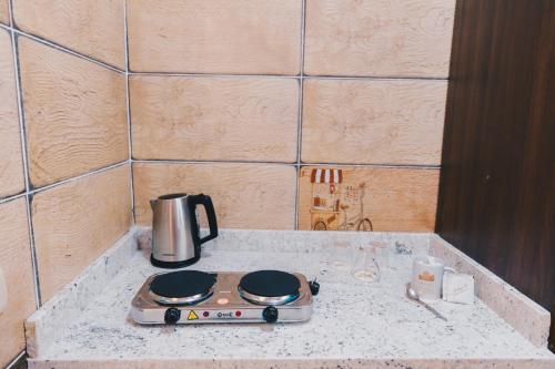 a stove top with a coffee pot on a counter at VIDA by Elegant Hospitality in Cairo
