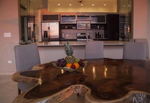 a bowl of fruit on a wooden table in a kitchen at Ocean View Villa With Pool and Spectacular Sunsets in Ballena