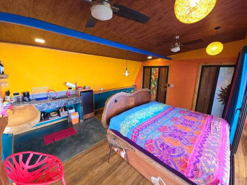 a bedroom with a large bed and a sink at El Sol Monteverde in Monteverde Costa Rica