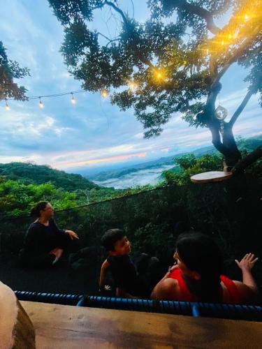 a group of people sitting on top of a hill at El Sol Monteverde in Monteverde Costa Rica
