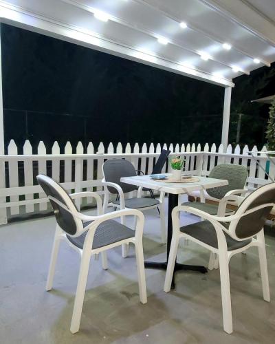 a white table and chairs on a patio at Suncoast Rooms Saranda near Port & Beach in Sarandë