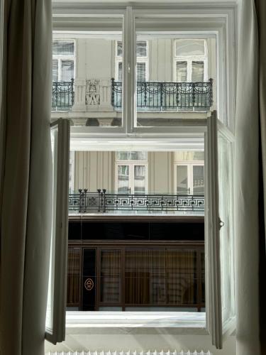 a window view of a building with a balcony at Opera Vienna Apartment 145 m2 in Vienna