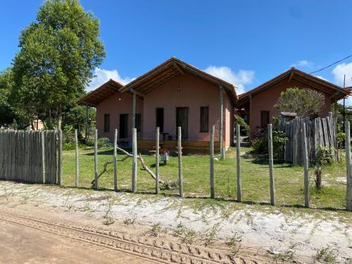 a fence in front of a house at Chalés Costa Amar in Porto Seguro