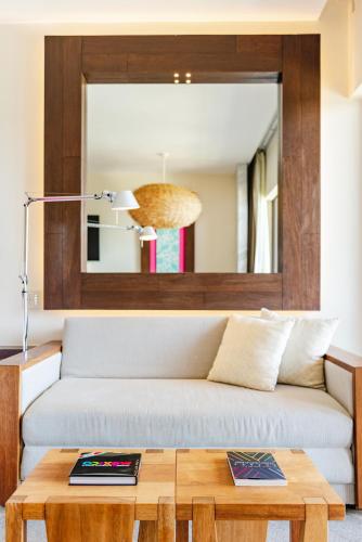 a living room with a couch and a table at Hotel Xcaret Mexico All Parks All Fun Inclusive in Playa del Carmen