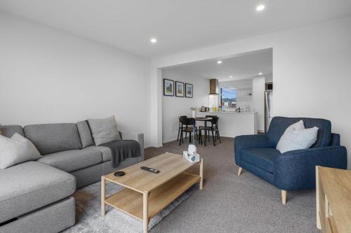 a living room with a couch and a table at City Centre Class in Christchurch