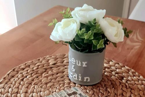 a vase with white flowers sitting on a table at Ferienwohnung Markelsbach in Much