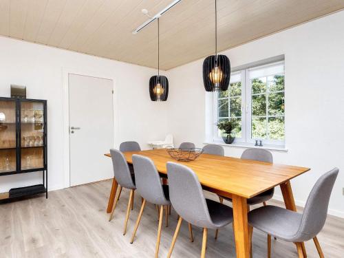 a dining room with a wooden table and chairs at 4 star holiday home in Farsø-By Traum in Års
