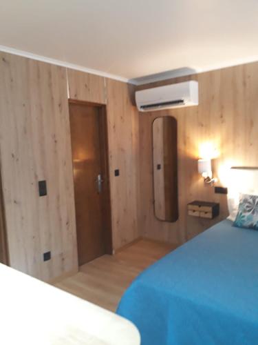 a bedroom with a bed and a room with a heater at Casa das Laranjeiras in Pinhão