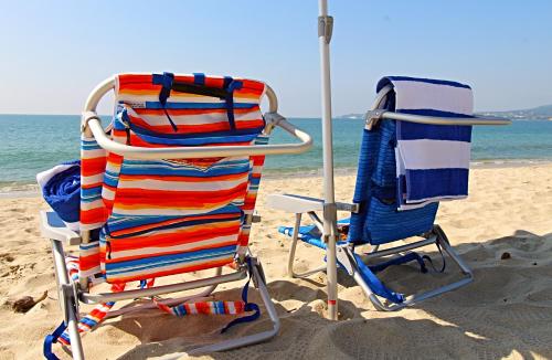two beach chairs sitting on the sand at the beach at Beach Loft LIFE Bucerías - Zona Dorada in Bucerías