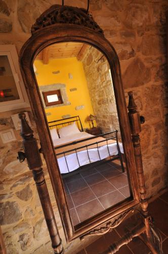 a mirror in a room with a bedroom at Akros Oreon Houses in Káto Sími