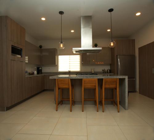 a kitchen with a island in the middle of a room at Voyage Vacation Club in Rosarito