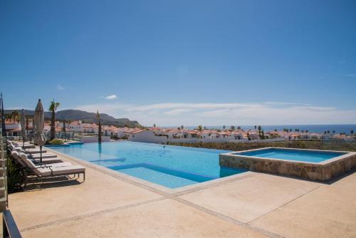 a swimming pool with a view of the ocean at Voyage Vacation Club in Rosarito