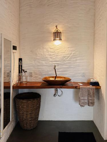 a bathroom with a sink on a counter at Casa da Mata Corumbau in Corumbau