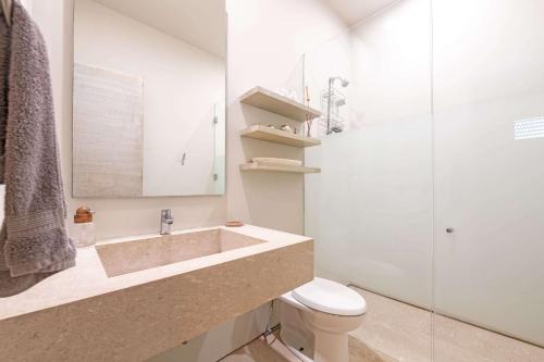 a bathroom with a sink and a toilet and a shower at Beachfront house in Kupuri Punta Mita in Puerto Vallarta