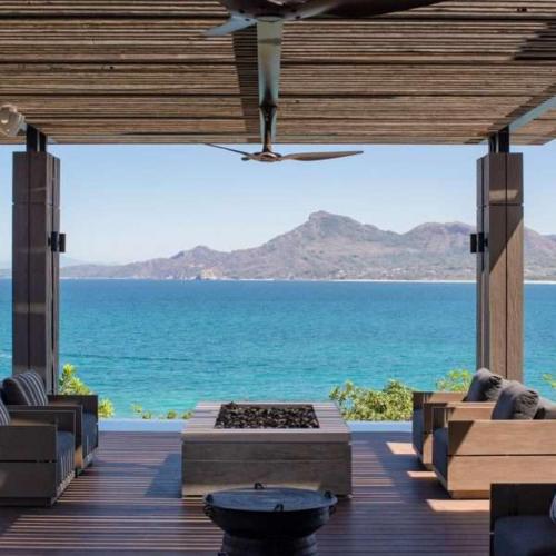 a view of the ocean from a porch with a view at Beachfront house in Kupuri Punta Mita in Puerto Vallarta