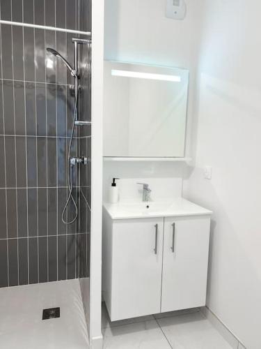 a white bathroom with a sink and a shower at Studio in Lormont with Free Parking in Lormont