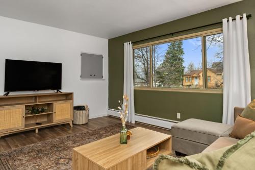 a living room with a flat screen tv and a couch at Modern Comfort Apartment in Great Falls in Great Falls