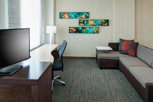 a living room with a couch and a tv at Residence Inn by Marriott Clearwater Beach in Clearwater Beach
