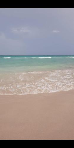 a beach with the ocean in the background at Dar Dhiafa Mayar -دار الضيافة ميار in Mahdia