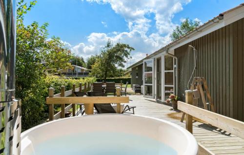 a bath tub sitting on a deck next to a building at Lovely Home In Haderslev With Wifi in Haderslev