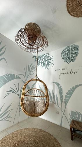 a wicker basket hanging from the ceiling in a room at Hotel Casa Puerta de Mar in Campeche