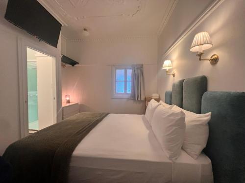 a bedroom with a large bed with a window at Floriana Boutique Hotel in Cairns