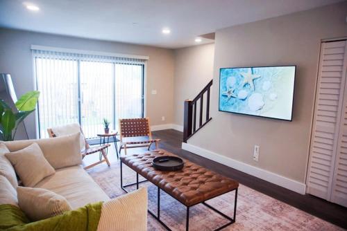 a living room with a couch and a table at Boho Townhouse near USF in Tampa
