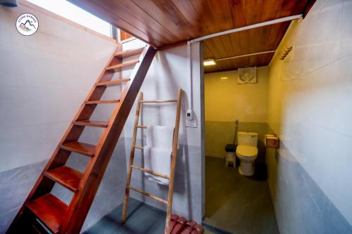 a bathroom with a staircase leading to a toilet at Stone Garden Resort & Spa in Sa Pa