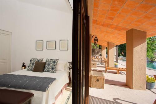 a bedroom with a bed and a patio with a pool at LA ROCA 8 min WALKING DISTANCE TO THE BEACH in San José del Cabo