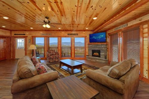 a living room with a couch and a fireplace at Summit Pool Lodge in Little Cove