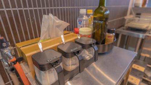 a kitchen with a counter with a bottle of wine at NEW OPEN ！1日1組限定、海すぐの一軒家を完全貸切別荘！島の自然を五感で味わえる体験型ホテル in Shikashima