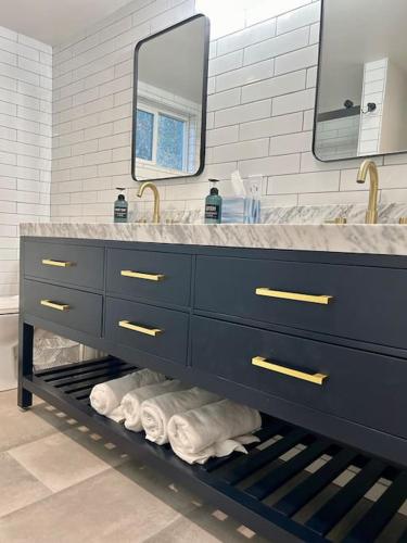 a bathroom with a sink and a vanity with towels at The Drey in Big Bear City
