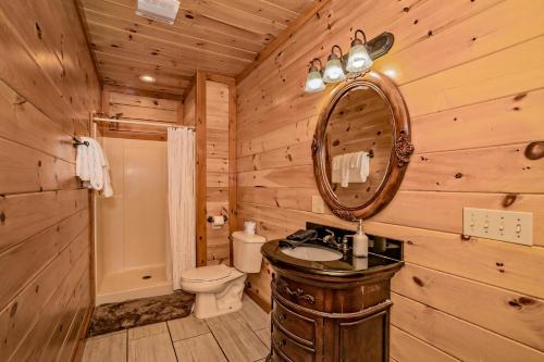 a log cabin bathroom with a sink and a mirror at Indoor Pool Beauty in Cosby