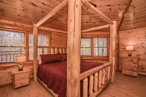 a bedroom with a bed in a log cabin at Indoor Pool Beauty in Cosby