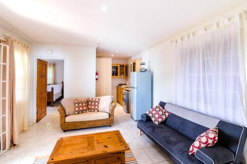 a living room with a couch and a table at Woburn Villas in Saint Georgeʼs