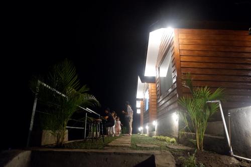 a group of people standing outside a building at night at Pondok Alengkong in Bangli