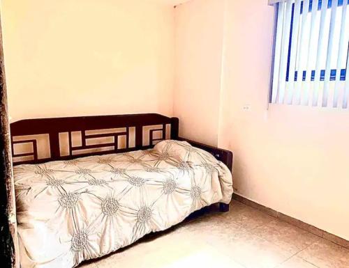 a bedroom with a bed in a room with a window at Brand New Apartment Loft in Cananea