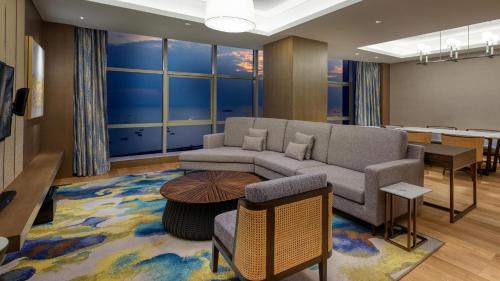 a living room with a couch and a table at Crowne Plaza Beihai Silver Beach by IHG in Beihai