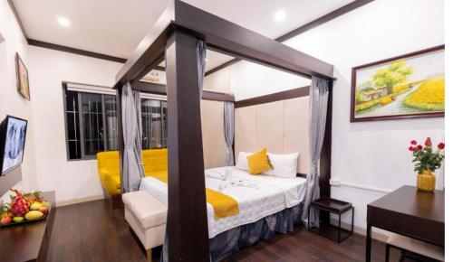 a bedroom with a canopy bed in a room at Hanoi Cozy Legend Hotel in Hanoi
